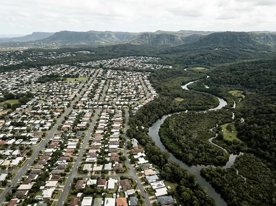 Aerial view of the South East Queensland edge where suburbs meet bushland and a creek line
