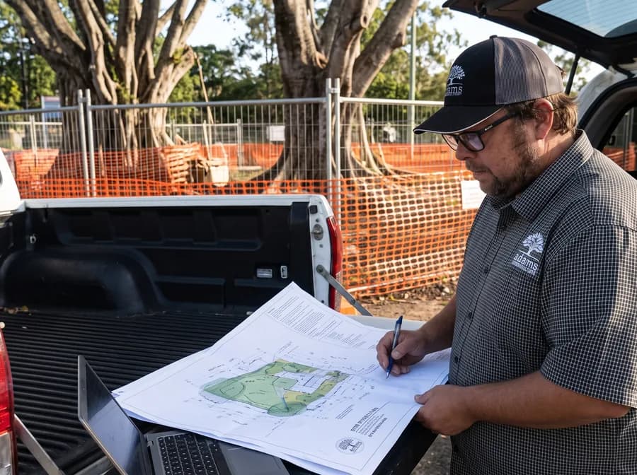 Site plans spread across the open tailgate of a ute on site
